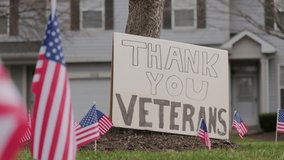 Close up of Slow waving many American flags blowing in the wind on a cloudy day. Patriotic concept for US holidays, Veteran's day. Close up shot - Powered by Shutterstock - Get 15% off with code: PIKWIZARD15