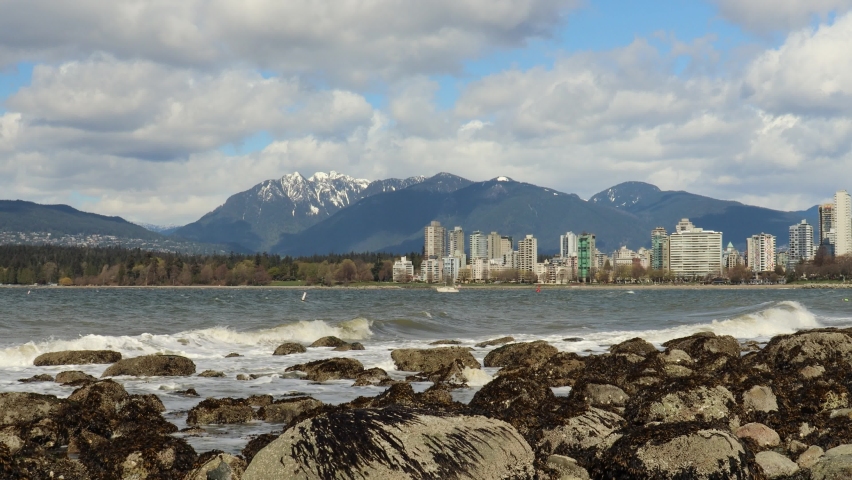 Stormy sunny day in Vancouver with view of the mountains behind downtown