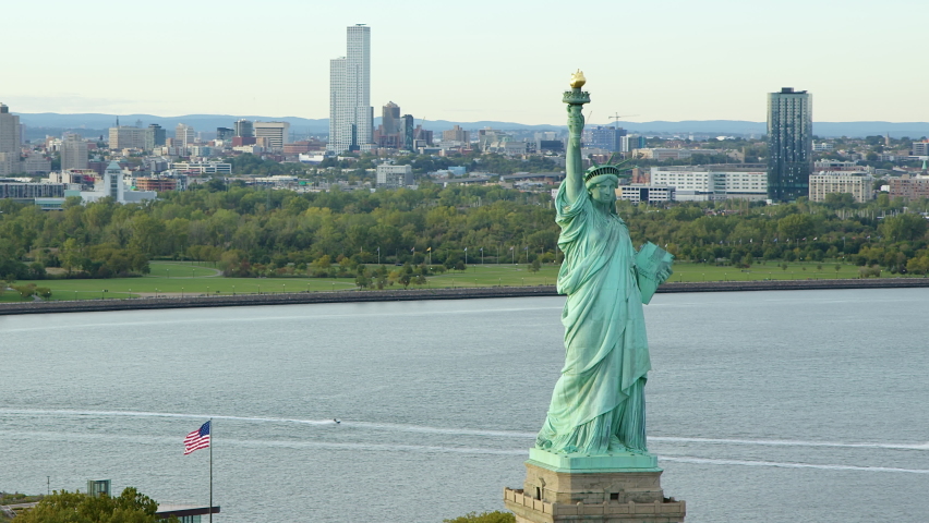 
Aerial View Of The Statue Of Liberty Orbiting At Daylight, New York City. New York Aerial Shot. Wide Shot. 
US. Flag.  United States. High Quality Footage Shot from Helicopter.
 Royalty-Free Stock Footage #1097882789