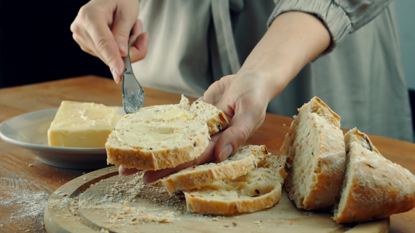 Freshly Baked Sourdough Bread. Handcraft Lunch Food. Butter On Bread. Dairy Culinary. Breakfast Food Tradition. Natural Wheat Organic Breads Slice. Butter Spread Knife. Making Sandwich On Breakfast Royalty-Free Stock Footage #1097891035