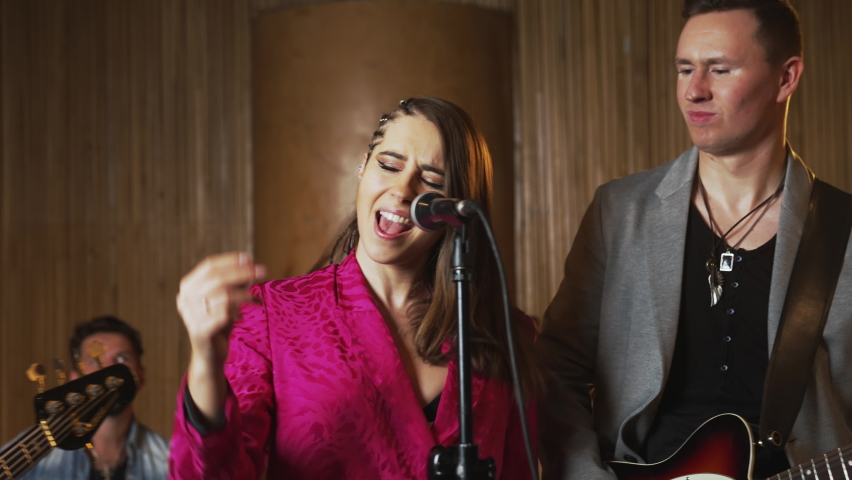 Music band having a rehearsal in a studio. High quality 4k footage