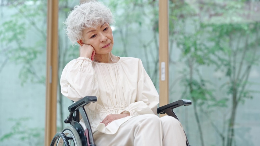 Depressed elderly Asian woman sitting on wheelchair. Royalty-Free Stock Footage #1097898581