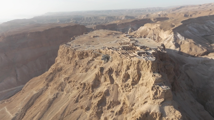 Masada National Park ,Israel table top summit, sunrise aerial drone view flying back
