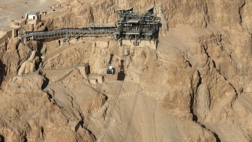 Masada National Park ,Israel cable car gondola lift going up the snake trail to the top of the mountain, aerial view
