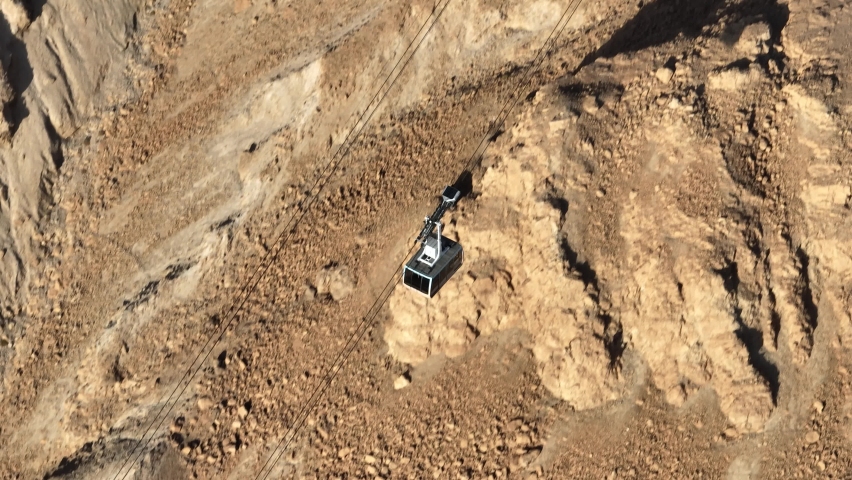 Masada National Park ,Israel cable car gondola lift going down the snake trail from the top of the mountain, aerial view
