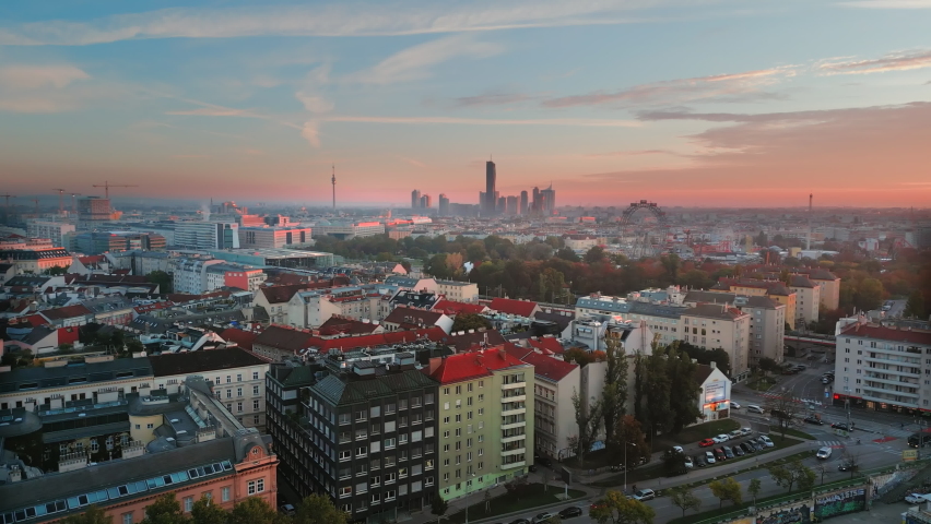 Aerial View of Viennese Giant Ferris Wheel in Vienna, Austria at sunset colored sky, vienna skyscrapers downtown view skyline panoramic.