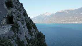 Cinematic flight in 4K along the coast on lake garda of a drone showing the traffic along the coastal roads and hairpin bends
