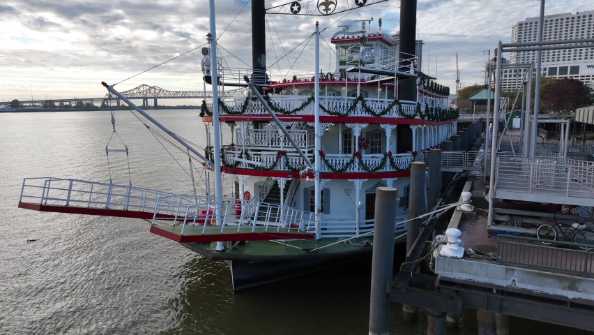 New Orleans Riverboat on Mississippi River in NOLA. Big Easy tourist attraction. Rising aerial of boat decorated at Christmas season.