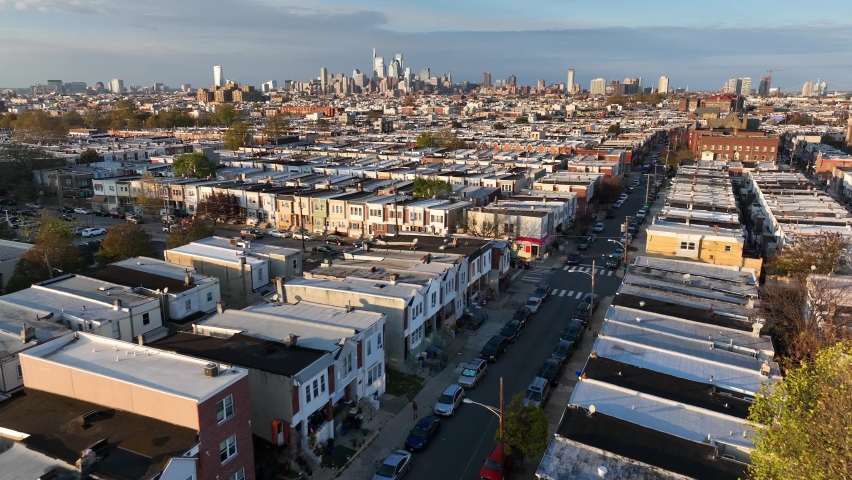 Poverty theme in poor housing community in USA. African American population center. Aerial during golden hour light.