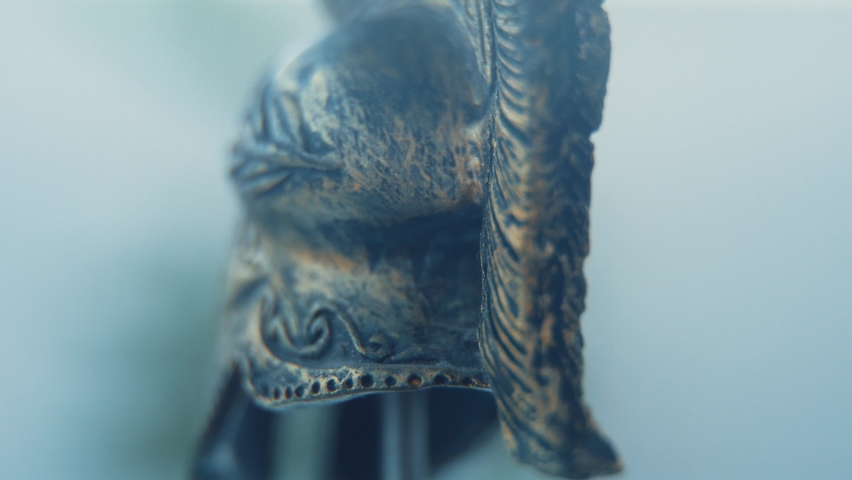 A rotating close up macro shot of a spartan warrior metal gold helmet, 4K Royalty-Free Stock Footage #1097913723