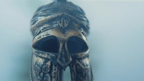 A rotating close up macro shot of a spartan warrior metal gold helmet, 4K - Powered by Shutterstock - Get 15% off with code: PIKWIZARD15