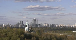 4K bright spring afternoon high quality video of Grebnoi rowing water sports channel and distant Moscow City high-rise modern buildings, suburb Krilatskoye, near Moscow River in Russia