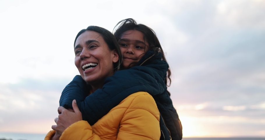 Latin girl hugging her mother on the beach at sunset during winter time Royalty-Free Stock Footage #1097922379