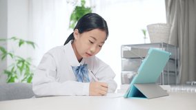 Asian female student studying with a tablet PC. Online class. e-learning.