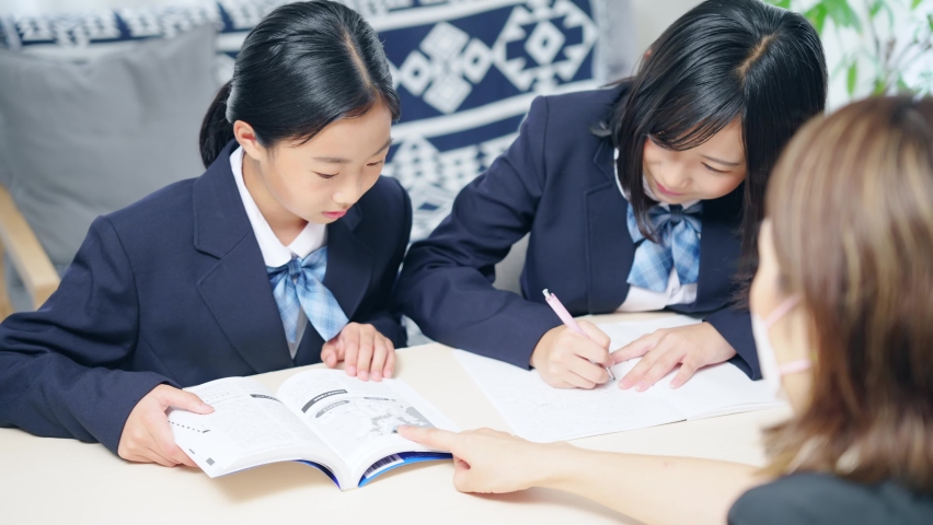 Asian schoolgirls receiving guidance in the room. | Shutterstock HD Video #1097924235