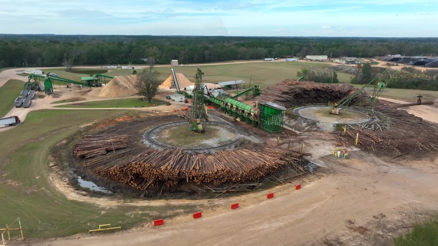 Pulpwood forestry tree grinder operation. Machinery and equipment used to grind logs into pulp. Aerial view.