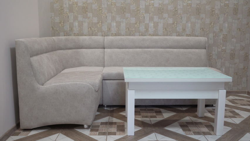 a sofa with a coffee table,a room for receiving and relaxing guests, the interior of the living room kitchen, a modern sofa in the kitchen