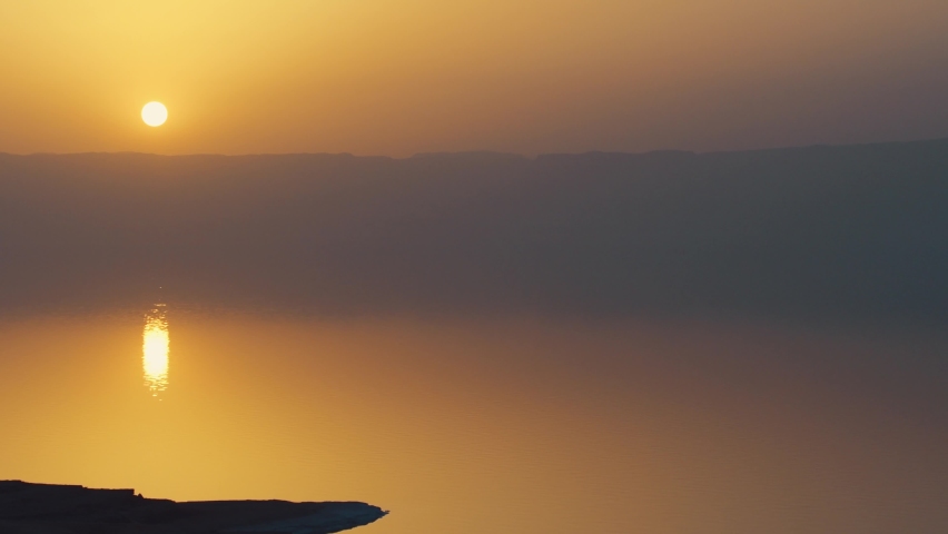 Scenic panoramic view of dead sea shoreline in misty evening on sunset from viewpoint in Jordan