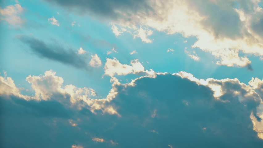 Sunny spells through forming clouds on evening sky time-lapse background.Climate change weather forecast copy space. Stormy clouds form in the sunny skies concept Royalty-Free Stock Footage #1097941341