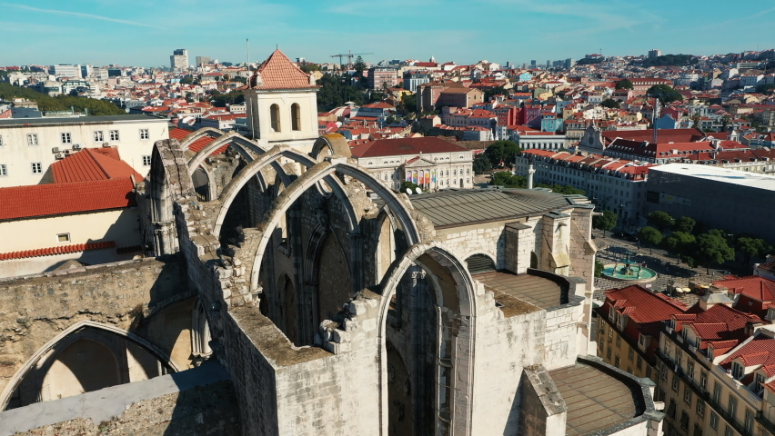 Historical city centre views of Lisbon, the capital of Portugal. On a sunny summer day, red rooftops, the famous Santa Justa lift and Carmo Convent in the focus of footage.