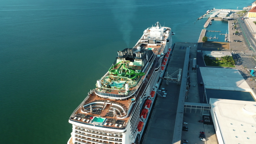 Cruise ship docked at the Lisbon Cruise Port . Historical city centre views of Lisbon, the capital of Portugal. Aerial views of red rooftops, Tagus river, marina and historical architecture.