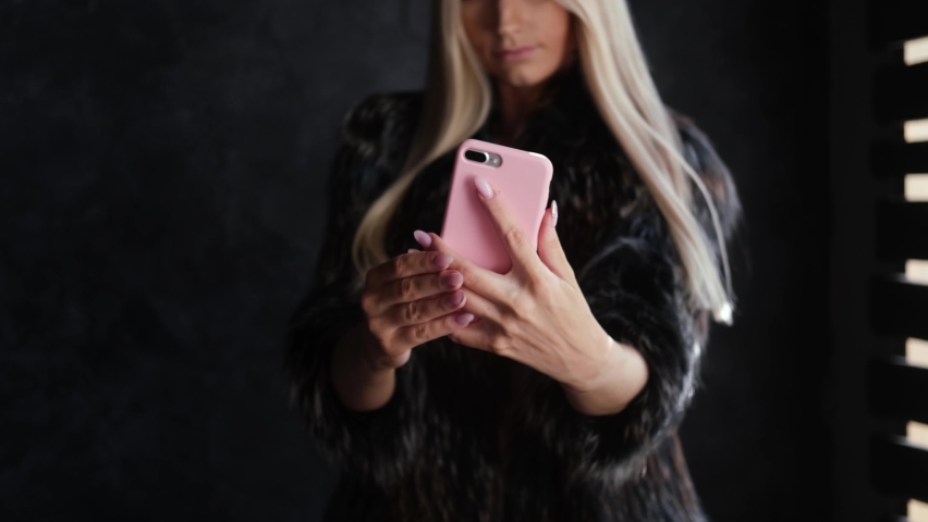 "Fashionable beautiful blonde woman in a fur coat