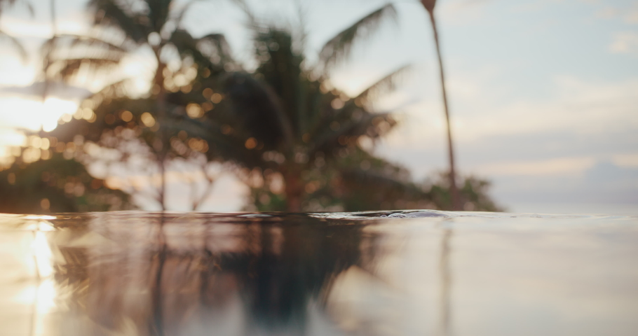 Woman relaxing in the pool at luxury resort spa at sunset, health and wellness rejuvenating tropical vacation Royalty-Free Stock Footage #1097954735