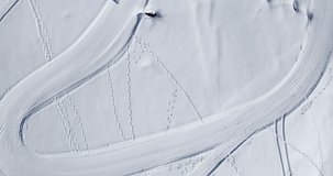Aerial top shot of Husky sled dogs on a snowy track in the French Alps. Alpes d'Huez