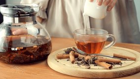 Cup Black Milk Tea . Brewed Herbal Leaf. Pouring Milk On Tea Cup. Indian Masala Chai. Morning Breakfast Hot Teapot. Brewing Tea Milk On Hot Teapot Morning. English Breakfast Hot Drink Chai From Cattle - Powered by Shutterstock - Get 15% off with code: PIKWIZARD15