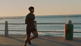 Man, music earphones or running by sunset beach, ocean or sea in healthcare workout, marathon training or cardio wellness. Runner, sports athlete or sunrise exercise with radio music in slow motion - Powered by Shutterstock - Get 15% off with code: PIKWIZARD15