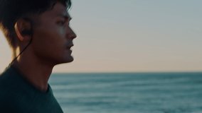 Running, music and beach of man in fitness training for speed, energy and competition with wellness, podcast or mental health audio. Earphones, sea and sports runner with exercise, cardio or workout - Powered by Shutterstock - Get 15% off with code: PIKWIZARD15