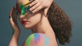 Fashion, makeup and color with woman and face art, colorful aesthetic with cosmetics beauty portrait against studio background. Rainbow, facial and lipstick, creative marketing and hand frame. - Powered by Shutterstock - Get 15% off with code: PIKWIZARD15