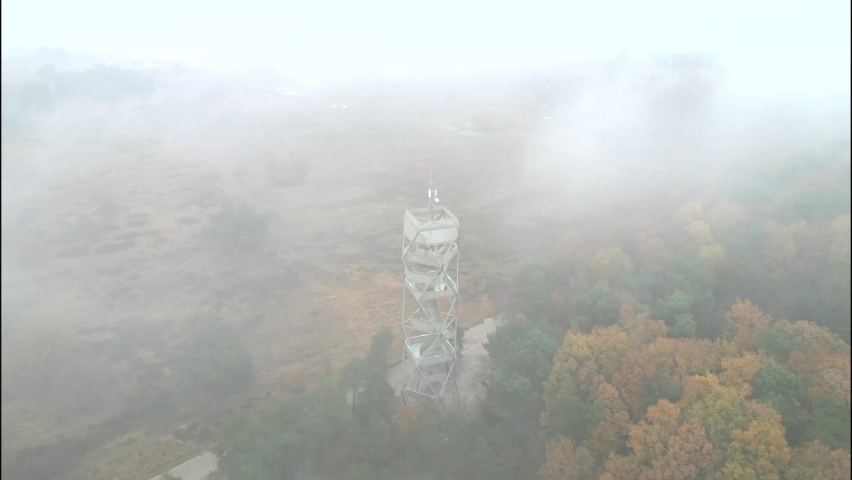 Fire Watching Tower Tourist tower provides a great view over the Kalmthout Heath. Aerial shot of a cloudy Heather landscape.