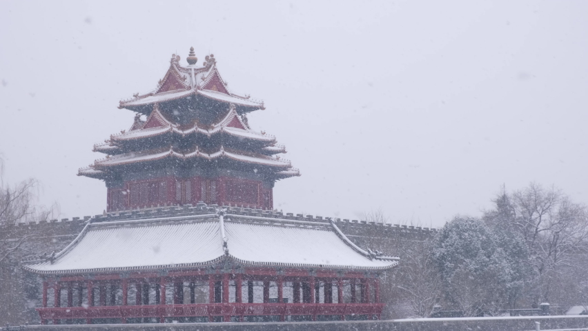 Corner tower of Forbidden City stands in heavy snow, Beijing, China.