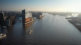 Aerial footage of harbor, Elbphilharmonie, Hafencity and downtown in Hamburg, Germany, Europe. Aerial footage of ferry across the Elbe near Hamburg Elbphilharmonie. 