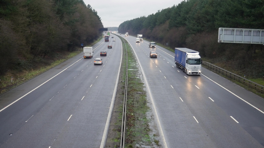 The M1 Motorway road in the UK. Cars and lorries travel along the highway in England on a wet winter day. | Shutterstock HD Video #1097982669