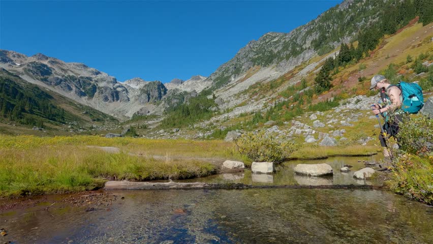 Adventurous people hiking in Canadian Mountain Landscape. Sunny Fall Season. Brandywine Meadows near Whistler and Squamish, British Columbia, Canada. Adventure Travel. Slow Motion Cinematic