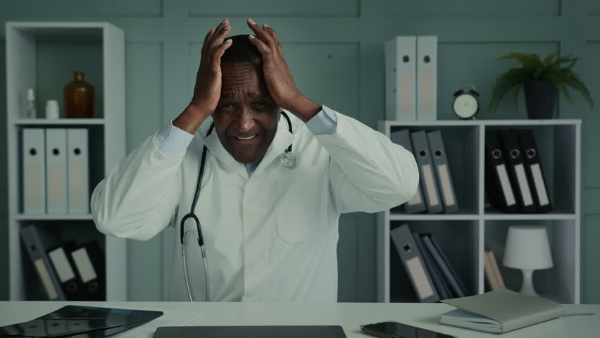 Stressed male doctor desperate sad elder surgeon african man worried about professional mistake tired male physician practitioner suffering from guilt or headache thinking of grief depression thoughts Royalty-Free Stock Footage #1097991123