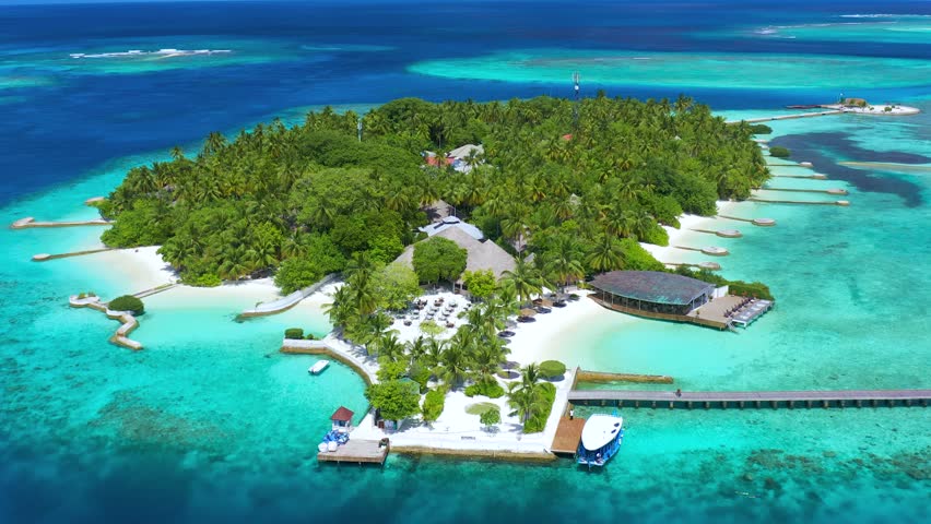Tropical island with watrer villas and coconut palm trees, blue lagoon, white sandy beach at Bora Bora island, Tahiti, French Polynesia. Aerial drone view. Royalty-Free Stock Footage #1097992257