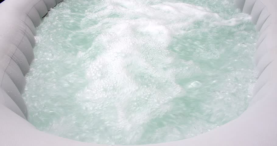 Mid shot of an inflatable hot tub stopping it air jets, bubbles Royalty-Free Stock Footage #1097996967