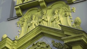 biblical saint from bible Christianity carved sculptures on a wall of church detailed extravagant historical beings holding a cross yellow greenish colour god Jesus Christ detailed close up ancient
