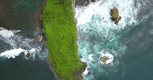 Drone head shot of Tropical beach with coral island, Indonesia. big waves sea.