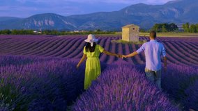 Couple of men and women are on vacation at the Provence. Lavender field France, Valensole Plateau, a colorful field of Lavender Provence, Southern France. Lavender field. Europe.  - Powered by Shutterstock - Get 15% off with code: PIKWIZARD15