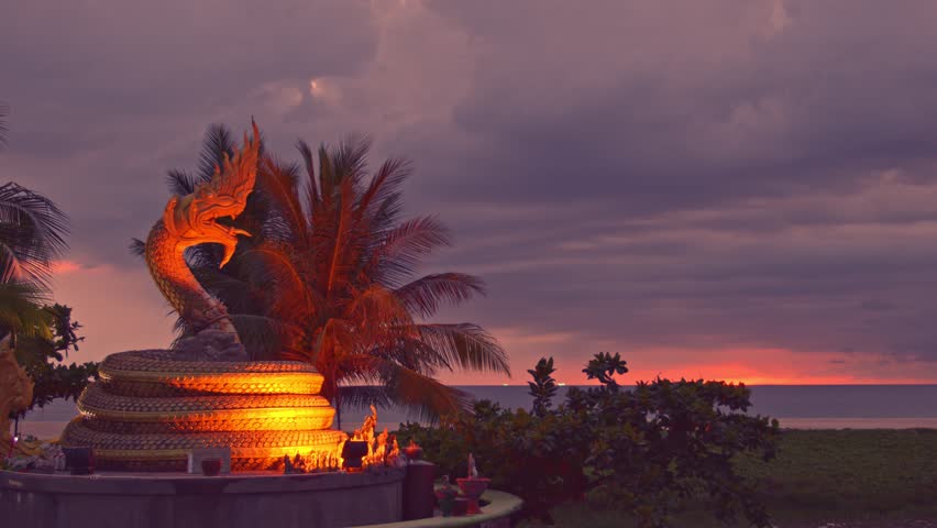 
Scenery sunset behind Naka god of snake statue in the middle of Karon beach Phuket.
Karon beach is a beach is broad and long. 
Sand and beautiful beach suitable for swimming.
cloud scape background.
 Royalty-Free Stock Footage #1097999837