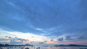 time lapse beautiful sunrise above fishing boats on Rawai beach, Phuket,Thailand.
light through the cloud to sky above fishing boats.
video 4K. Scene of Colorful red light in the sky background.
