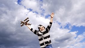 Happy senior man imagine flying on wooden plane in sky, aviator game - Powered by Shutterstock - Get 15% off with code: PIKWIZARD15