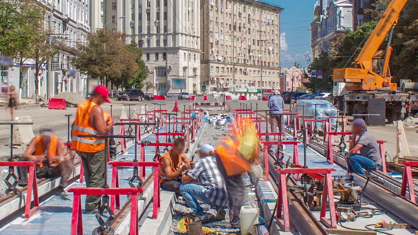 Tram rails at the final stage of their installation and integration into concrete plates on the road timelapse with crane. Filling by liquid resin for reduction of vibration and noice. The process of