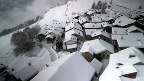 Aerial view small mountain village after heavy snowfall. Winter season. Video 4K