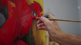 Details: hand of male artist using paintbrush brush, applying oil paint across the canvas, while drawing an author painting in creative studio. Painter creating still life with red poppies on canvas - Powered by Shutterstock - Get 15% off with code: PIKWIZARD15