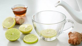 Serving lemon honey tea in a glass cup